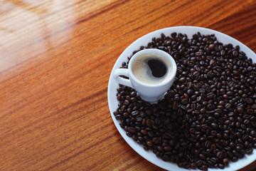 Cup of coffee and roasted coffee beans