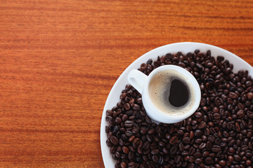 Cup of coffee and roasted coffee beans
