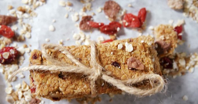 Granola bars tied with string on wax paper 