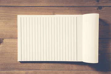 blank notebook on brown wood table