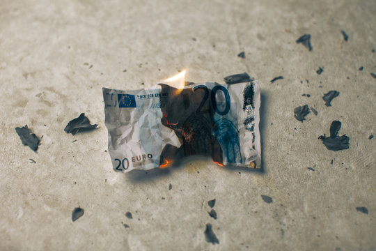 Burning twenty euro banknote