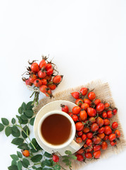 dog rose hips and herbal Te a on white background 