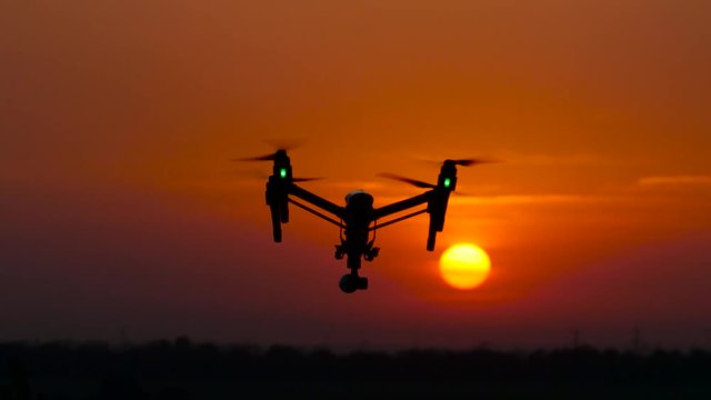 Aircraft flies, in the background a crimson sunset, he flies away