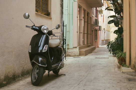 Black Italian scooter parked in the alley