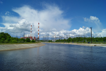 Fototapeta na wymiar RUSSIA, PERM - JUNE 12, 2015: spillway and building of machine room on thermal power station in Dobryanka, Perm Krai