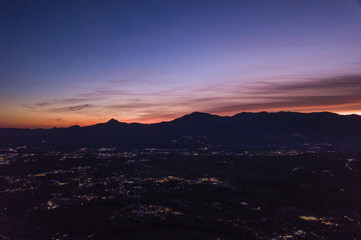 Aerial view of an incredible sunset behind the Italian mountains