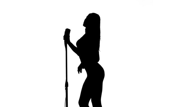Singer performs songs in a retro microphone. Silhouette. White background