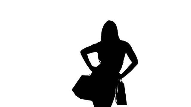 Woman packages in hands posing for cameras. Silhouette. White background. Slow motion
