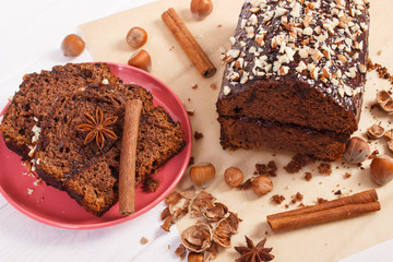 Gingerbread or dark cake with chocolate on boards, delicious dessert