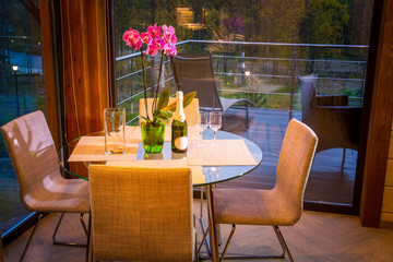 A table in the background of a panoramic window. Vacation home. Cottage.