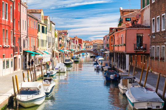 Colorful old houses and bridge over the canal at the island of Murano near Venice