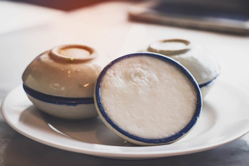 Thai dessert  (khanom thuay)  coconut milk custard in small porcelain cup   .