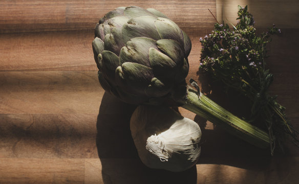 Artichoke, Thyme and Garlic on Chopping Board
