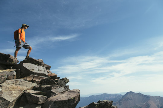 Male Hiker Standing On Mountain Summit