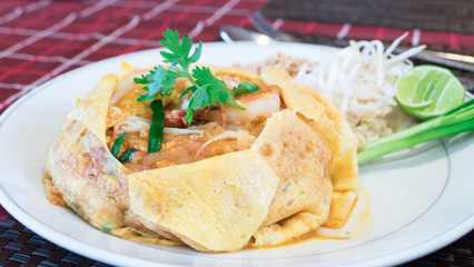 Pad Thai with shrimp and egg on dinner table