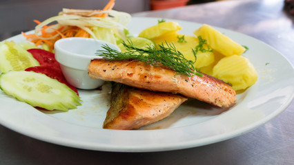 Salmon steak on white dish
