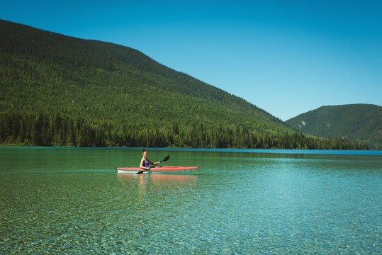 Woman kayaking in river