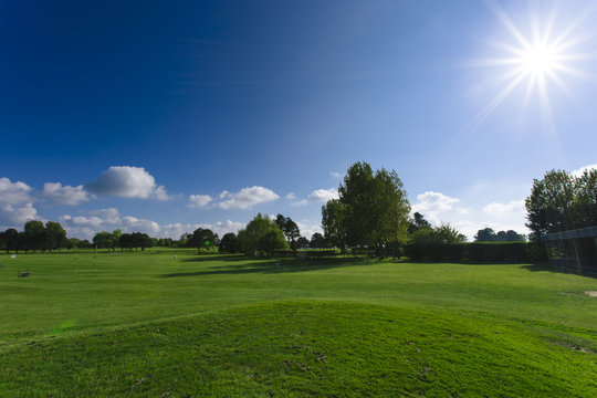 General view of a green golf course on a bright sunny day. Idyllic summer landscape. Sport, relax, recreation and leisure concept