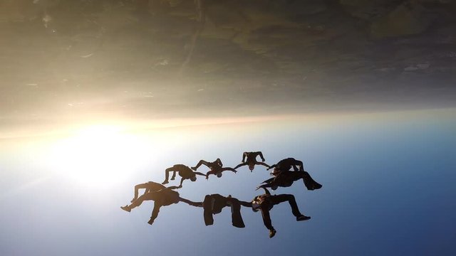 Skydivers at the sunset