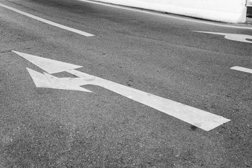 Arrow Symbol on Asphalt Road.