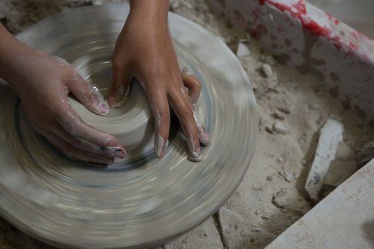 Hands of girl molding a clay