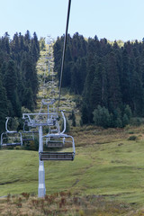 Fototapeta na wymiar cable car lift in a meadow among the trees of the forest