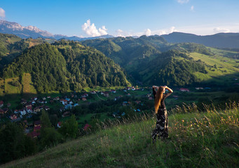 Beautiful girl, model in the mountains in the evening sun with a deep fog and perspective in Romania. Beauty, nature, style.