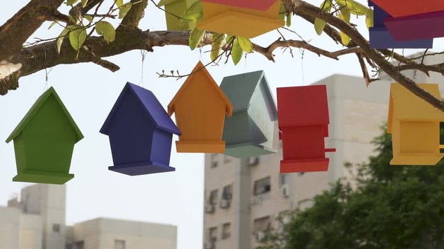 Colourful Wooden Bird Houses On the tree. Illustrate housing problem and mortgage loan