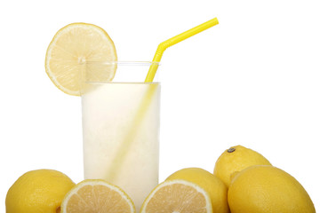 Close up of glass of lemonade surrounded by lemons. yellow straw, slice of lemon on side of cup, isolated on white background.