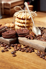 Obraz na płótnie Canvas Aroma coffee candy chocolate cookies and spices on the wooden table. Christmas sweets. Dark wooden background. Top view. Close. Closeup.