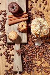 Aroma coffee candy chocolate cookies and spices on the wooden table. Christmas sweets. Dark wooden background. Top view. Close. Closeup.