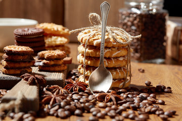 Aroma coffee candy chocolate cookies and spices on the wooden table. Christmas sweets. Dark wooden background. Top view. Close. Closeup.