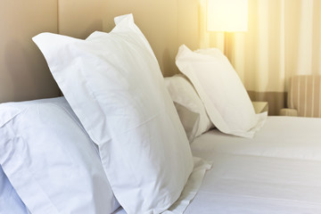 Fototapeta na wymiar Prepared fresh bed, scene in hotel room