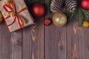Christmas gift boxes and fir tree  on wooden background.