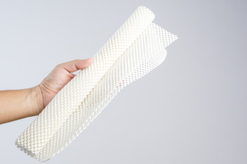 Hand holding white anti slip rubber mat for bathroom or wet floor