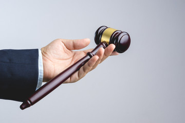 Business man hand sharing wooden judge's gavel as a law or justice sign