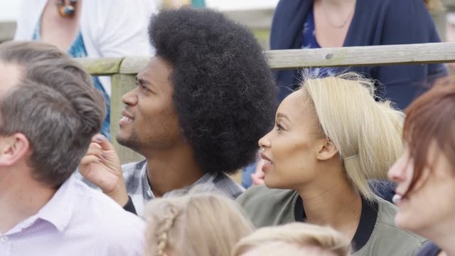  Families watching a demonstration at falconry center, focus on audience