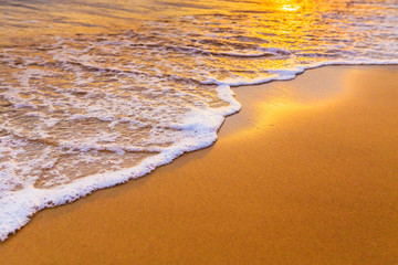 Waves on the beach in the tropics at sunset