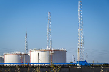 White large oil storage tanks against the blue sky.