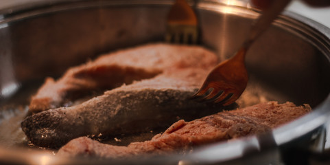 Fillet of fresh fish carp on a plate in flour ready for cooking.