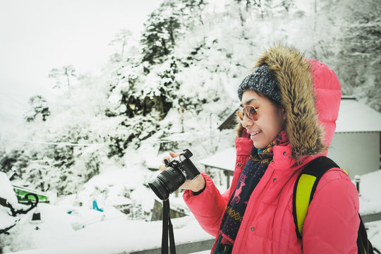 Asian girls travel Yamadata shrine during the winter at yamagata in japan And admire the pictures she took manually from a digital camera. Happiness and relaxation.