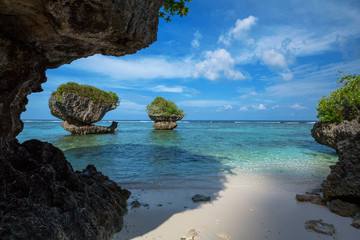 Tanguisson Beach on Guam's west coast offers calm, clear, warm waters and unique rock formations  - obrazy, fototapety, plakaty