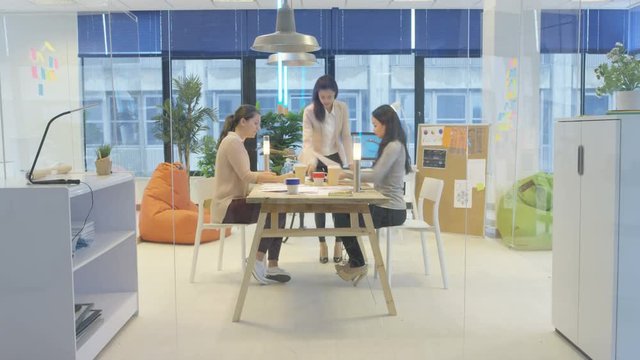  Time lapse female business team working together in creative office