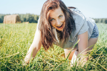 Girl in an autumn field with hay stack