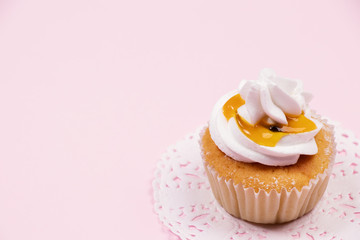 Valentine cupcake, Passion fruit caramel cupcake with butterscotch syrup on pink background.