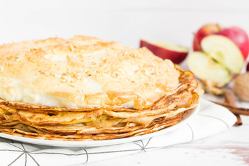 Meringue crepes stack with apples, cinnamon and walnut
