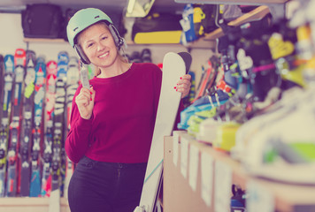 Portrait of female in helmet who is standing with ski
