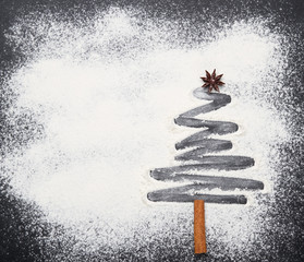 Christmas tree on flour background. White flour looks like snow.