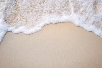 The movement of the waves on the sand is smooth and fine for  background,