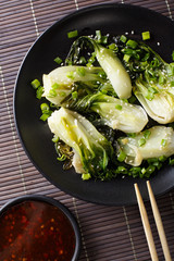 stir-fry spicy baby bok choy close-up. Vertical top view